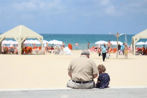 grandfather and child on the beach in Spain